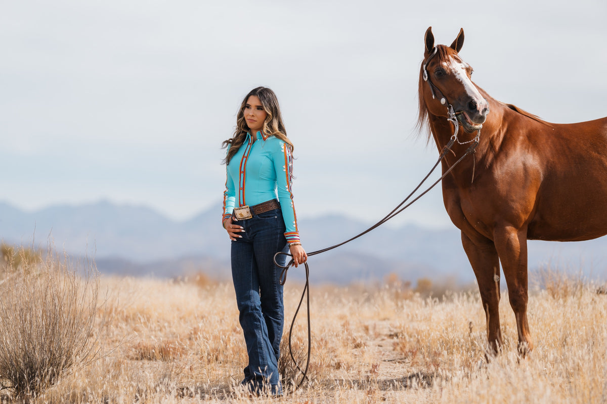 HSBD studio-made turquoise western shirt modeled beside a chestnut horse