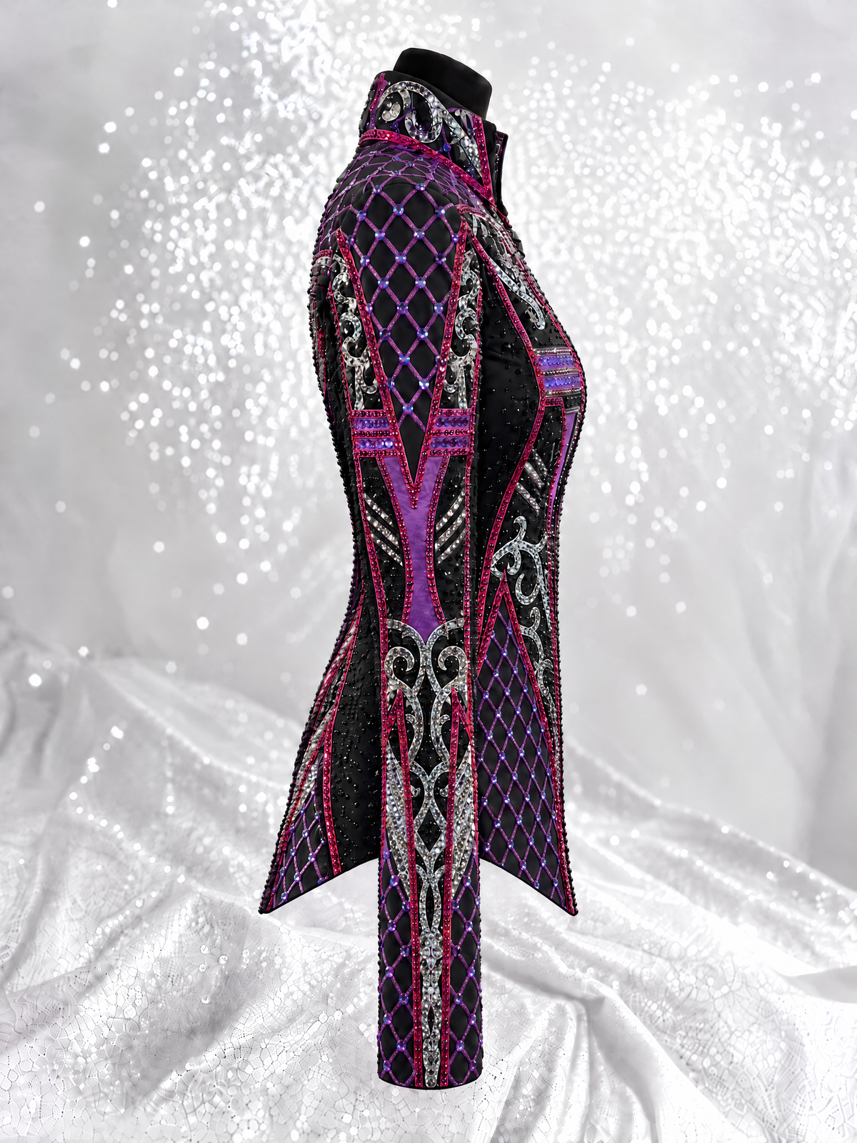 Side detail of a black showmanship jacket with pink and magenta geometric embellishment; Item 1538
