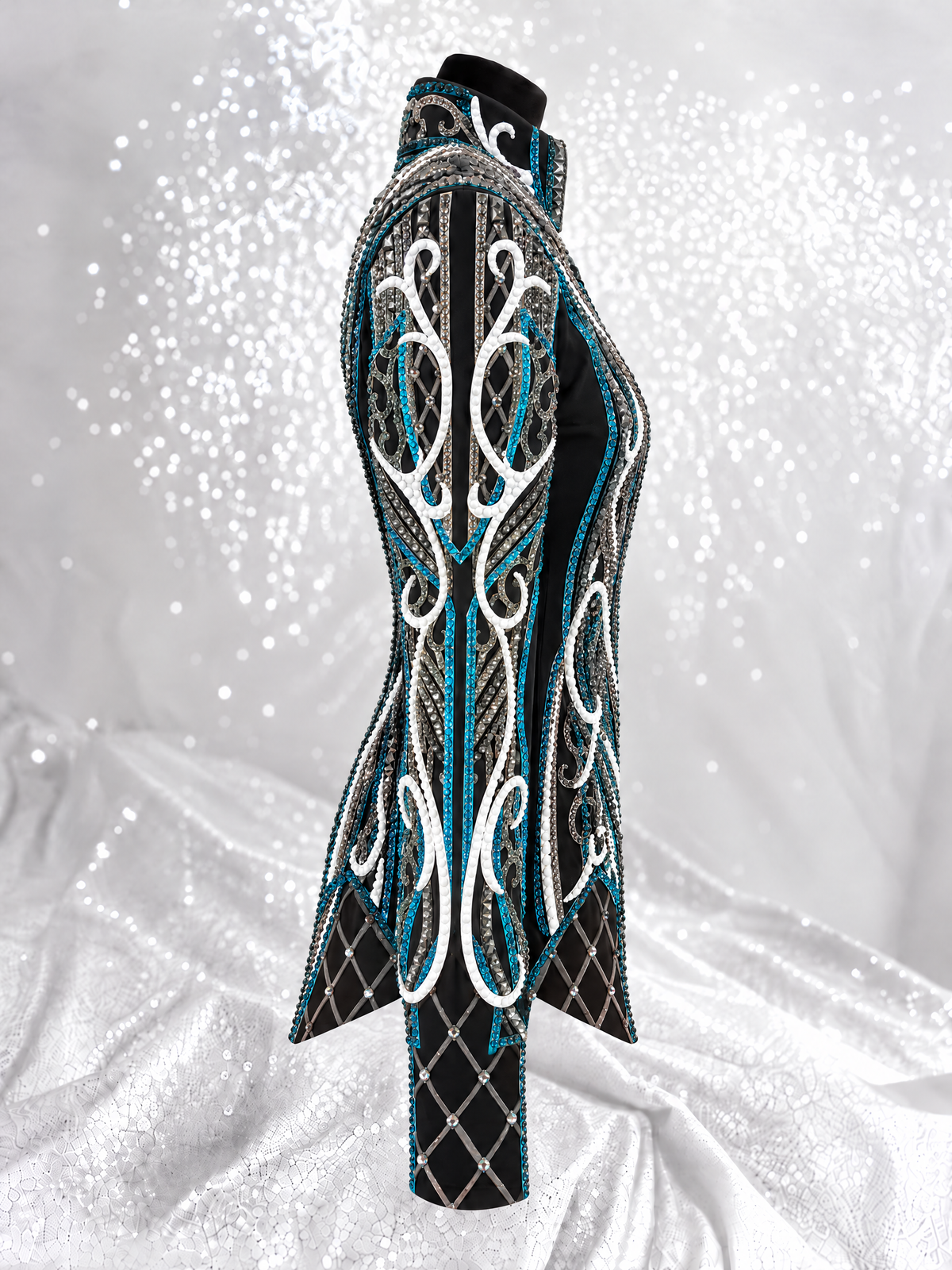 Side detail of a black showmanship jacket with teal and white embellishment; Item 1539
