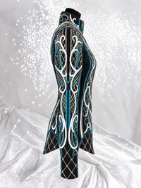 Side detail of a black showmanship jacket with teal and white embellishment; Item 1539